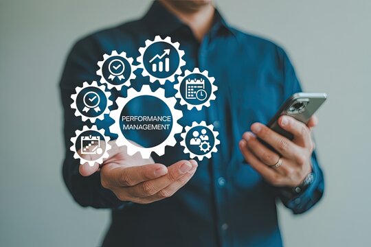 Business professional holding a smartphone and displaying a performance management concept with interconnected gears and icons