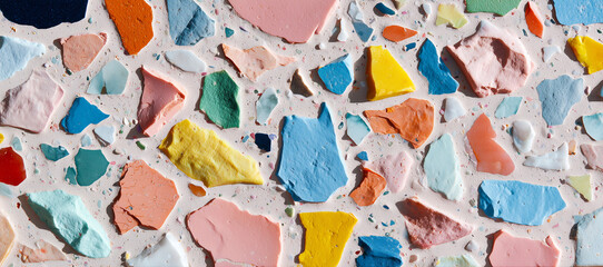 Colorful sea glass pieces scattered on a terrazzo surface.