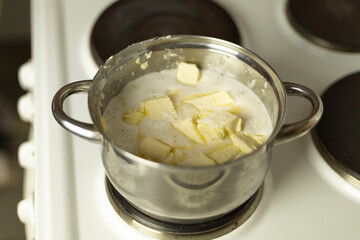 semi-melted butter in a saucepan on the stove