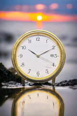 Vintage white round clock with brass frame showing time at 10:10