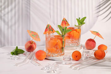 Lemonade cocktail with peach, apricot, mojito with tequila, gin, rum, vodka, liqueur, lime, ice and...