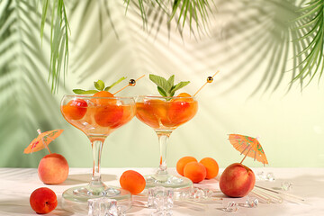 Modern still life with alcoholic cocktail or punch, peach, apricot and mint berries on elegant background, minimalist concept for bar and holiday party, cafe, advertising banner, selective focus,