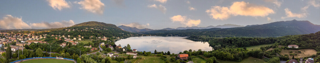 Aerial sunset view of Avigliana lake, Italy, Piedmont, Turin, Italy A beautiful town with and...
