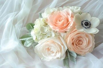 Obraz premium Delicate bouquet of pastel roses and anemones on sheer fabric.