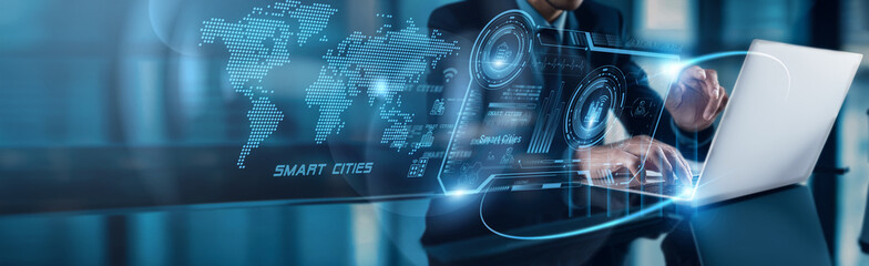 Businessman using laptop with analysis data of Smart Cities market growth projected to accelerate...