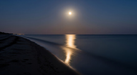 Fototapeta premium A bright full moon illuminates a tranquil beach at night, its light reflecting on the calm ocean waves