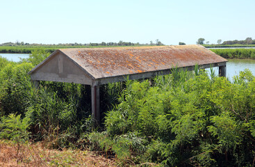 abandoned hut used by fishermen along the river bank where boats were moored