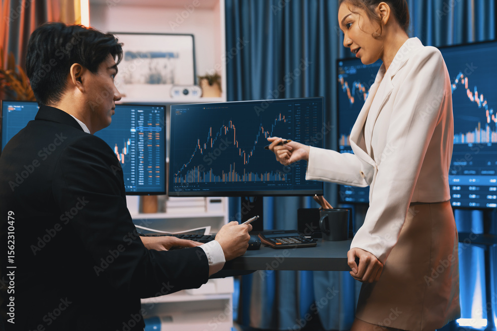 Poster smiling asian business traders pointing to dynamic stock exchange data screen profit value online we