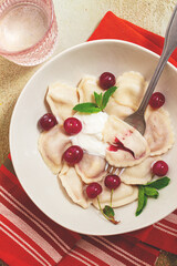 Traditional dumplings with cherries and yogurt, close-up, no people,