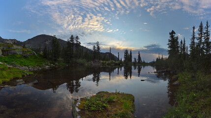 Russia. Krasnoyarsk Territory, Eastern Sayans. Summer evening on the shore of the Azure mountain lake in the natural mountain park Ergaki.