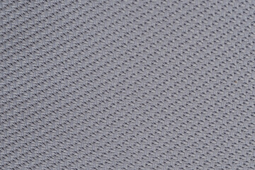 Textured fabric close-up showcasing intricate patterns and fine threads in soft light
