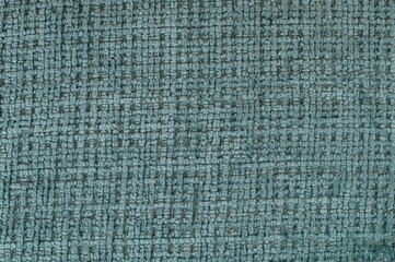 Textured fabric in muted teal shade with woven pattern on flat surface