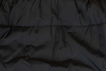 Textured black fabric showcasing soft, cozy warmth for winter fashion essentials