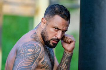Man boxer. Sweat flies, fists collide. Mans fight. Breath heavy, punches light. Dirt kicks up. In...