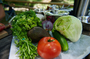 Fresh Vegetables and Herbs Arrangement on Outdoor Table During Daytime Picnic