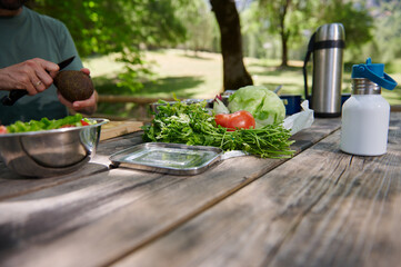 Preparing Fresh Salad Outdoors at a Scenic Forest Picnic Spot