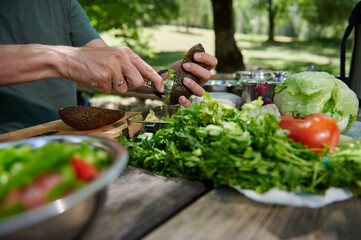 Culinary Preparation in a Scenic Outdoor Setting Featuring Vibrant Vegetables