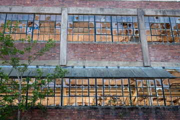 Broken windows on derelict industrial building on the Coventry canal at Athersone, Warwickshire