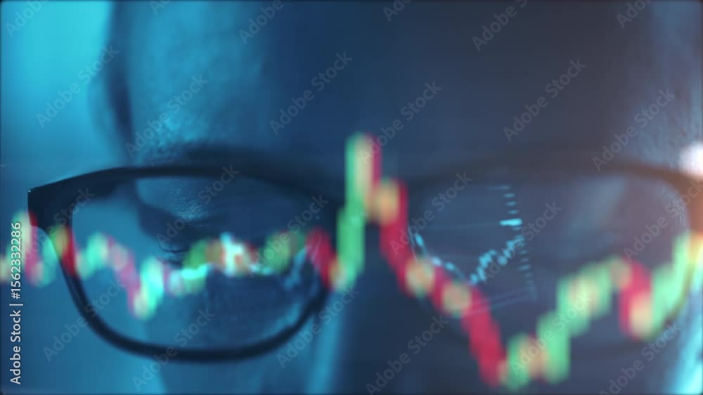 Poster trader wearing glasses is working on laptop computer. screen with stock market charts and bitcoin bt