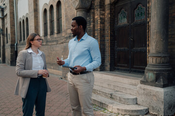 Business colleagues discussing work outside church building