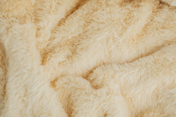 Soft beige fur texture for cozy winter fashion or interior design concepts