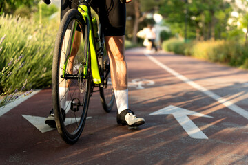 Professional cyclist walking with gravel bike on cycle path