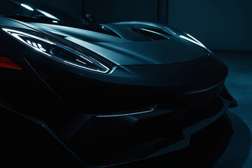 Black luxury sport car on a black background