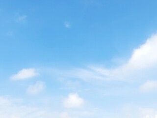 Blue sky background with white clouds in summer. Soft white clouds float in the clear blue sky. Clear blue sky, bright spring, soft sky gradient, wallpaper landscape, aerial view.