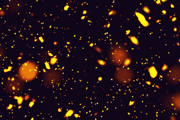 Abstract background of glowing orange and yellow particles on a dark backdrop