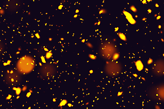Abstract background of glowing orange and yellow particles on a dark backdrop