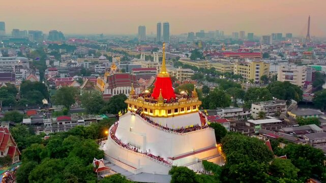 Golden mount temple stands tall in bangkoks cityscape at dusk