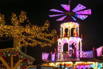 Colourfully illuminated Christmas pyramid at aChristmas market in Friedrichshafen, Germany. Symbol...