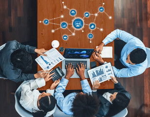 A diverse team works collaboratively on data analysis and strategy development, using technology...