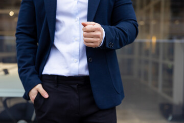 Close up picture of a man in a suit with his hand in the pocket