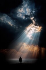 Silhouette of a person under dramatic heavenly light &ndash; divine atmosphere and spiritual energy