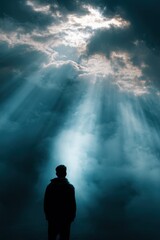 Figure standing in spiritual light from clouds &ndash; symbolism of awakening and inner journey