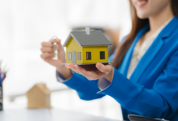 Home Ownership Dream: A model home is being presented with a set of keys to represent the idea of...