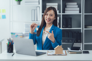 Key to a New Beginning: A confident and smiling woman, emblematic of a property expert, proudly...
