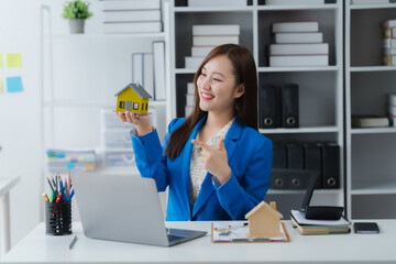 Dream Home Presentation: A smiling agent presents a miniature house model, symbolizing real estate,...