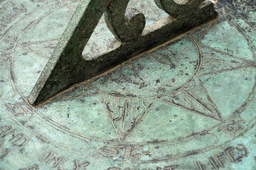 Close up  of sun dial wth verdigris 