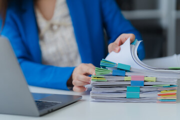 Workplace Documentation: A close-up shot of an office worker in a tailored blue blazer,...