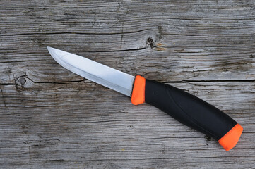 Knife on old wooden background. Top view. Copy space.