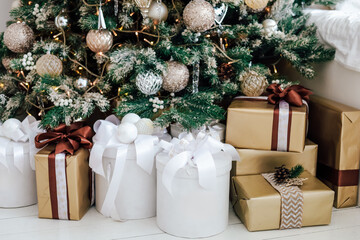 Christmas tree adorned with gifts and decorations in a cozy indoor setting near the holidays