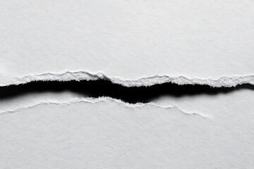 torn textured paper with rough edges revealing a dark gap in the middle ideal for creating contrast or highlighting a message
