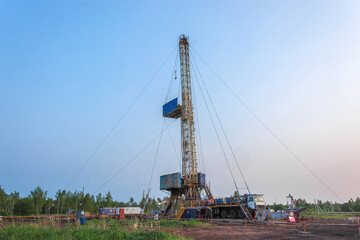 Drilling a well in an oil field. Mobile drilling rig and drilling equipment. Summer. Beautiful sky...
