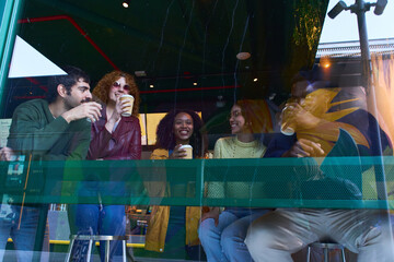 Group of diverse friends enjoying coffee together at a cafe