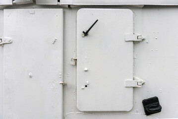 White metal door on an old ship.