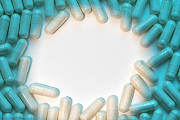 Close up of medical capsules on white background with blue shadows
