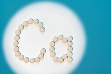 Calcium, Ca symbol made from pills on white background with blue shadows. Healthcare concept