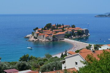 Breathtaking Panoramic View of Sveti Stefan Island in Montenegro, Showcasing its Historic Red-Roofed Buildings, Pristine Beaches, and Azure Adriatic Sea